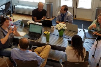 students_at_table_at_corner_office_building