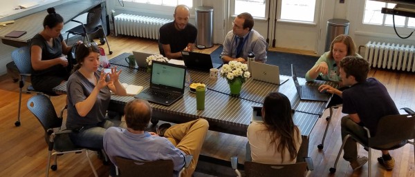 students_at_table_at_corner_office_building
